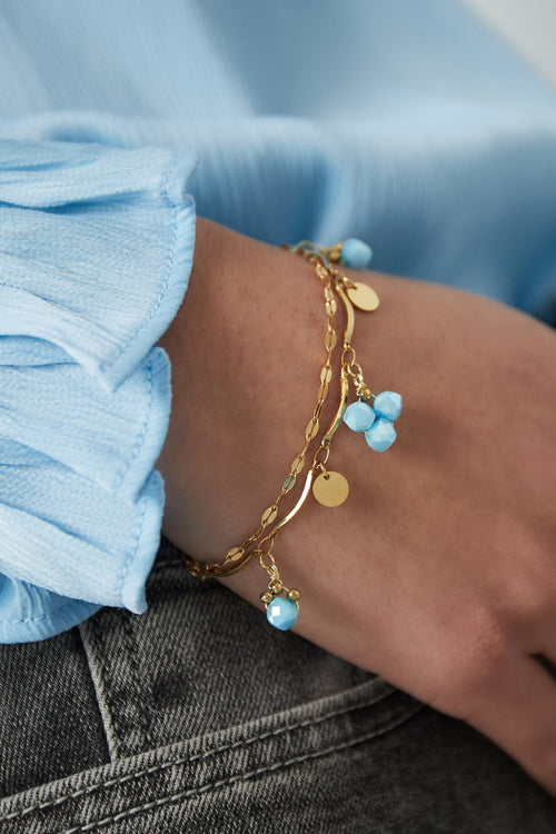 Goudkleurig armband met blauwe steentjes 